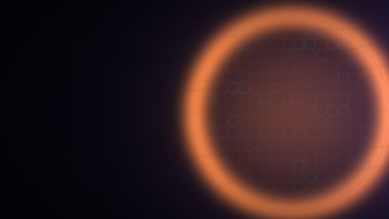 Glowing orange silicon wafer with a grid of chip dies on a dark background